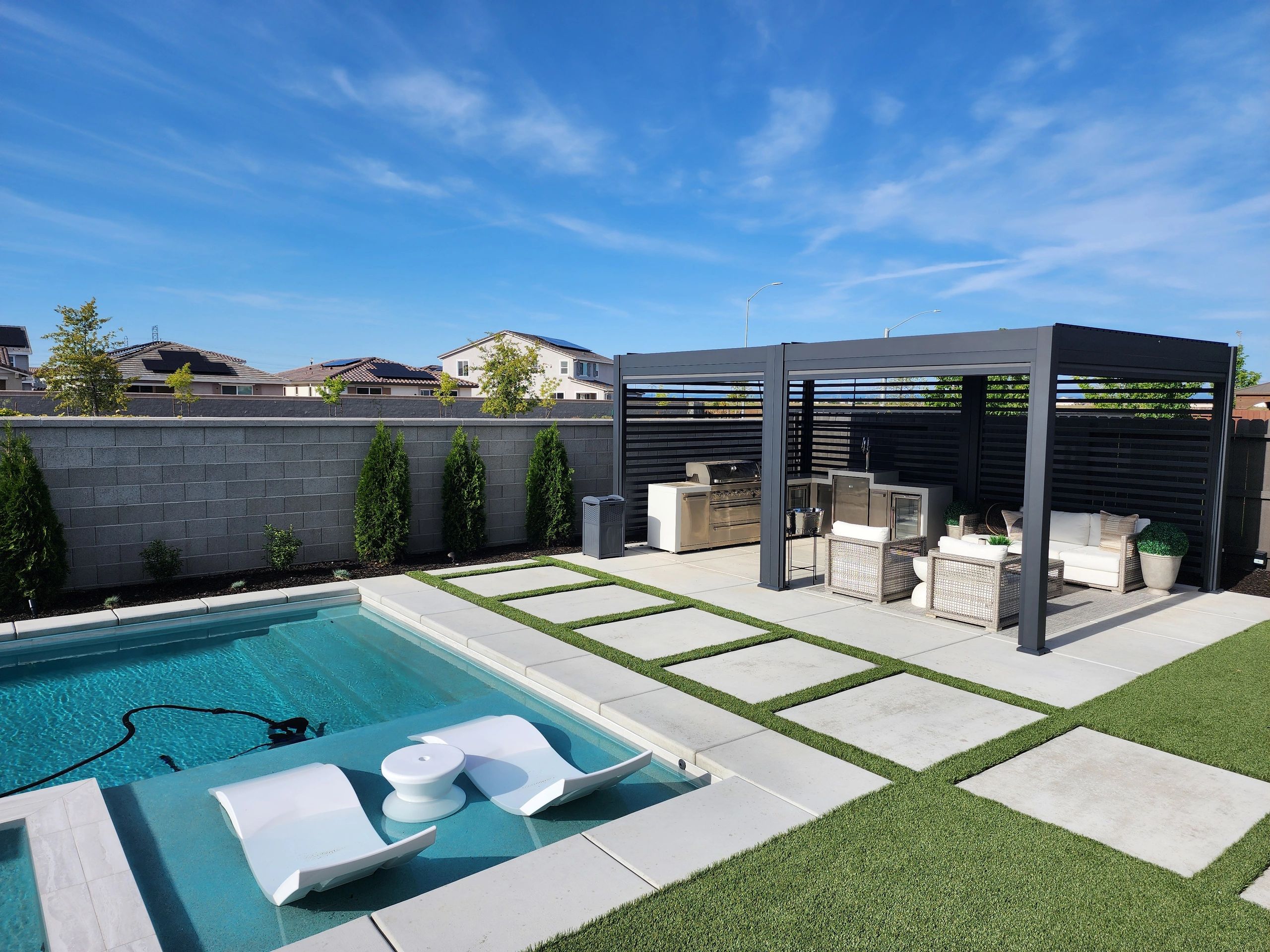 Backyard transformation with pool, pergola, turf, and hardscape
